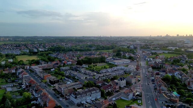 September 03, 2026 - Aerial 360-degree panoramic view of a Brussels suburb at sunset, showing urban areas and the surrounding green countryside.
