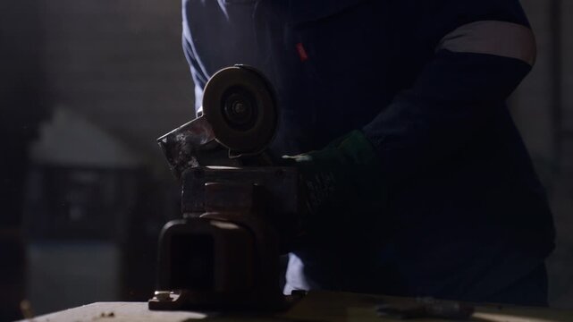 Slow-motion video of an angle grinder and sparks flying.