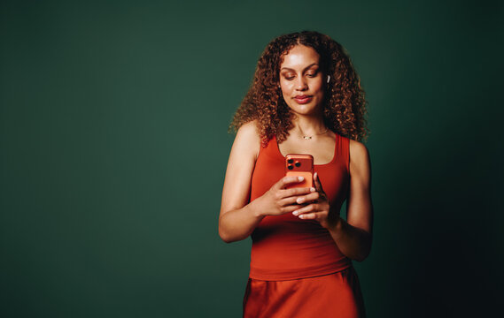 Woman using smartphone in studio for mobile communication and color branding campaign