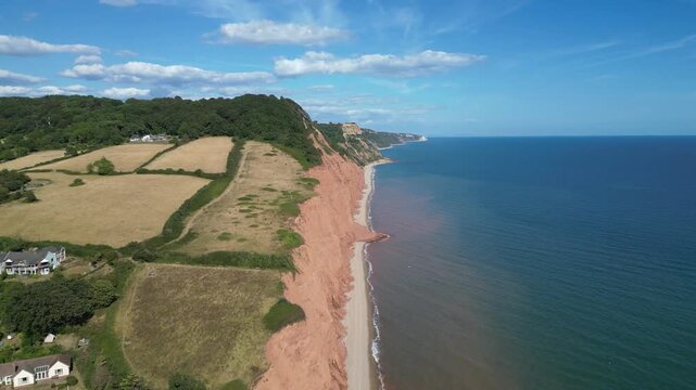 Sidmouth, Devon, England: DRONE VIEWS: The drone flies over red sandstone cliffs which form part of the Jurassic Coast and the East Devon AONB. The Jurassic Coast is a UNESCO World Heritage Site.