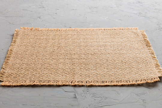 Perspective view of brown tablecloth for food on cement background. Empty space for your design