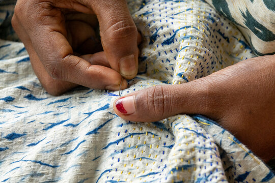 Artisan hand-stitching a kantha pattern on an indigo tie-dyed shawl at Living Blue, Rangpur Division, Goalpara, Bangladesh