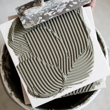 Close-up of notched thinset mortar applied to a tile