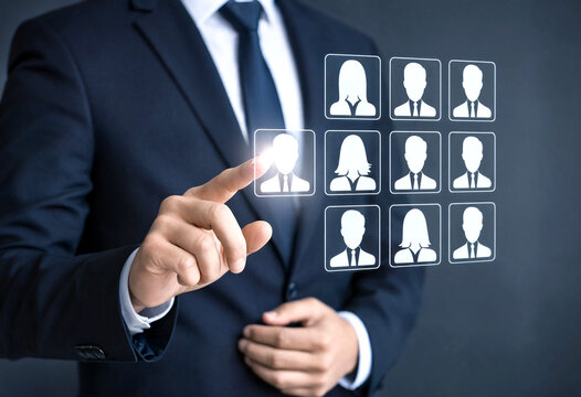 Business professional selecting a candidate profile on a digital interface with multiple user icons displayed