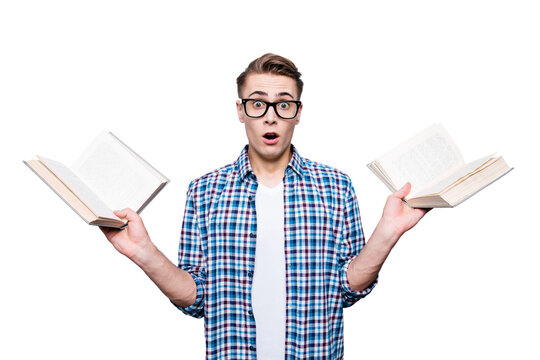Portrait of confused stylish handsome attractive nice trendy caucasian guy, wearing casual checkered shirt and glasses, holding two books, isolated over light grey background