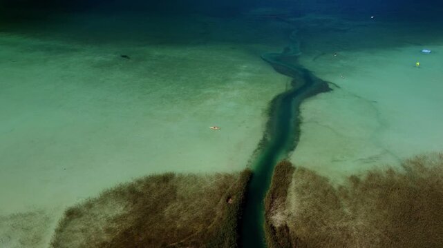 Cinematic Aerial Orbit of a Meandering River Channel in the Crystal Clear Waters of Lake Achensee, Austria