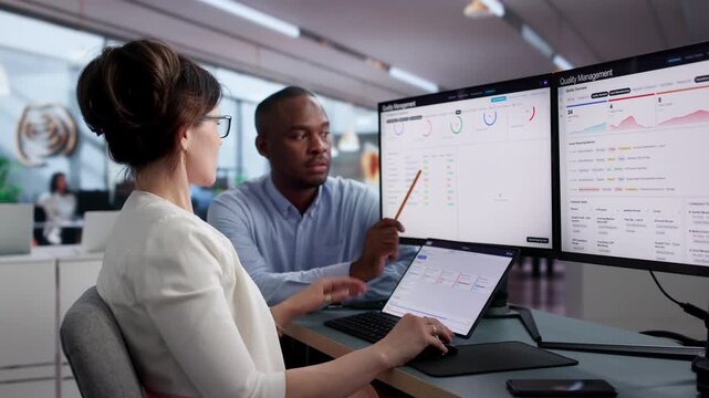 Quality Manager And Engineer Reviewing Software On Laptop
