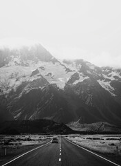 Obraz premium Beautiful view of a road leading to Mount Cook, New Zealand in grayscale