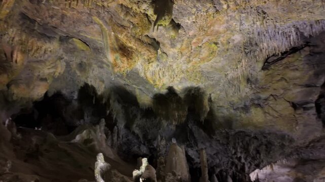 Textured limestone cave ceiling with dark formations