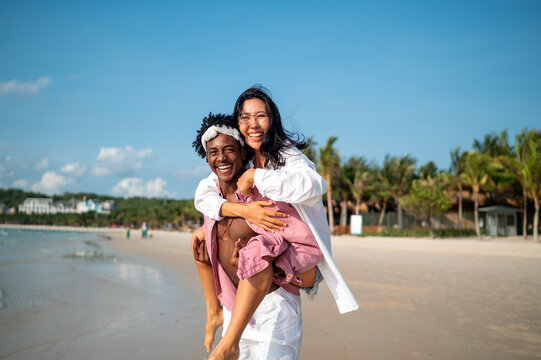 Carefree couple enjoying a tropical beach vacation, laughing making unforgettable memories together