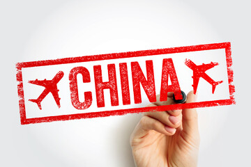 CHINA stamp held by a hand in closeup, showing bold travel destination wording in a rough frame, ideal for tourism, aviation themes, journey planning, global trips, promotion visuals for mediause © dizain