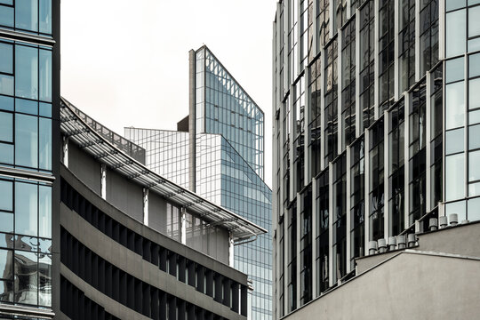 Urban architecture with office buildings and glass facades layered across the city in a geometric perspective that brings several buildings together within one view