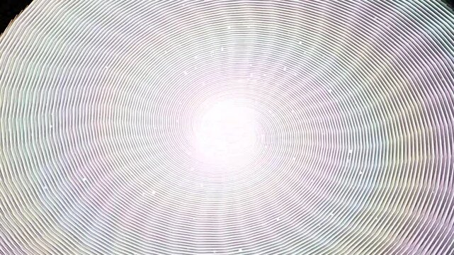 Abstract background with repeating circular lines creating a hypnotic tunnel effect with soft glowing light in the center and subtle rainbow moire pattern distortions 4k Motion Video