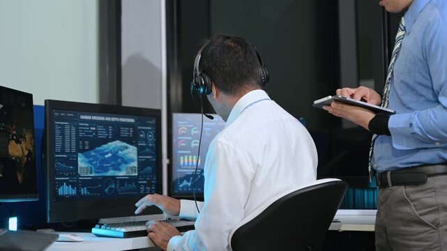 Two Asian male operators analyze global shipping and harbor data on digital screens. Teamwork