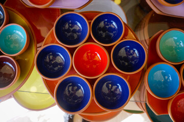 Colorful glazed terracotta ceramic bowls stacked on display