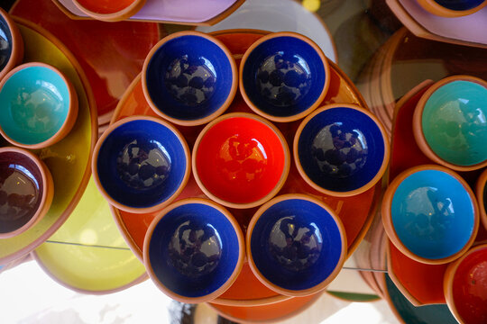 Colorful glazed terracotta ceramic bowls stacked on display
