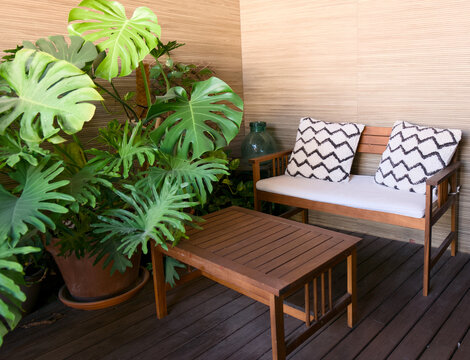 Stylish Balcony with Wooden Furniture and Plants