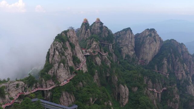 Epic cloud‑sea scenery of Laojun Mountain peak, spectacular golden‑top Taoist building complex surrounded by thick fog in central China