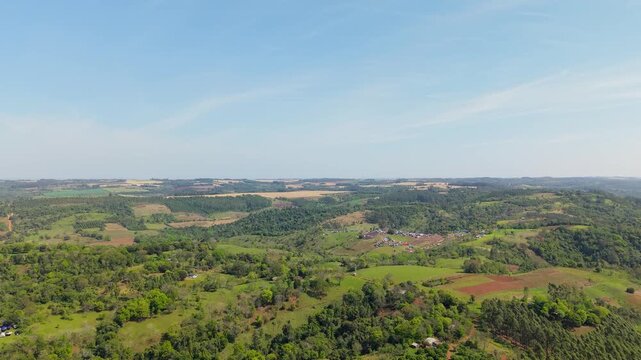 Aerial view captures WRC Rally 2026 camping grounds in lush Nueva Alborada, Paraguay, revealing rolling green hills, tents, and vibrant rural scenery under clear sunlight.