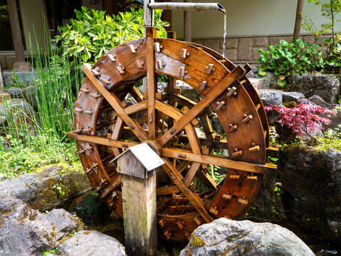 old wooden water wheel in garden
