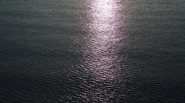 Calming sea surface with shimmering sunlight reflections