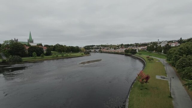 Calm evening view along the Nidelva river with Nidaros Cathedral spire