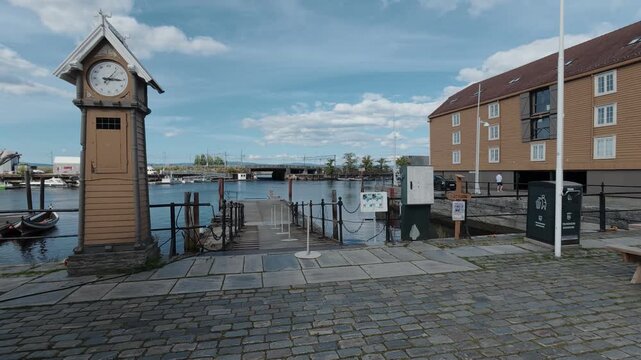 Wooden clock tower on the cobbled quay at Ravnkloa harbour Trondheim