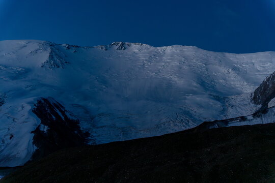 Lenin Peak north face glows blue before dawn, Kyrgyzstan