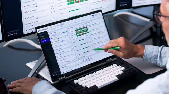 Caseworker Using Laptop To Manage Client Benefits