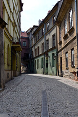 Fototapeta premium Lublin, Poland. Streets of Lublin Old Town lined with historic tenement houses, showcasing traditional architecture, narrow streets, and the unique atmosphere of this Polish city.