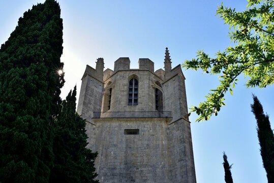 Lagrasse abbey, Aude, France, close-up, trees and blue sky background