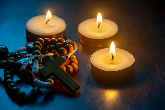 Holy Rosary with candle light background.