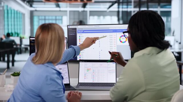 Financial Analyst Reviewing Budget Versus Actuals