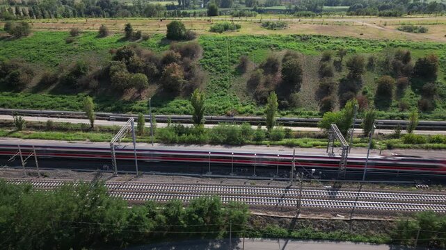 Europe, Italy , Milan - Frecciarossa Hight speed 300km h train railway from Milan  to Rome view from the drone - the faster way to travel in Italy for tourist and passengers - tourist destination 