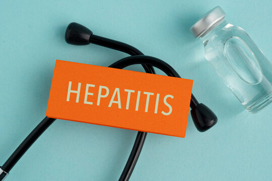 Stethoscope and a paper with the word Hepatitis. Contact with blood, semen or other body fluids from an infected person. Medical concept. Immunization protocol and prevention.