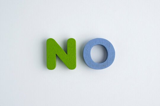 Colorful wooden letters spelling No. close up with copy space, rejection concept.