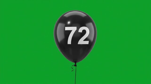 Black balloon with number 72 floating on green screen