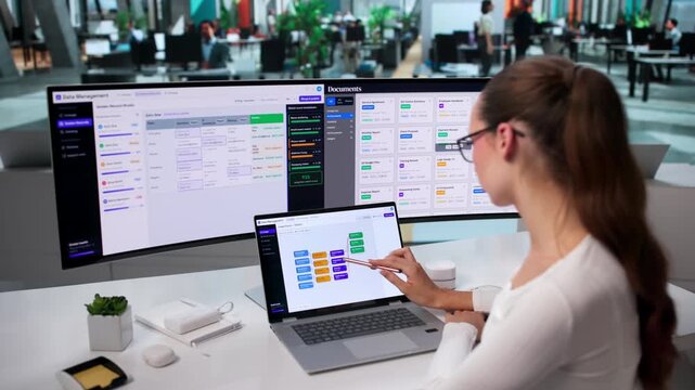 Data Manager Carefully Reviews Enterprise Catalog On Her Laptop
