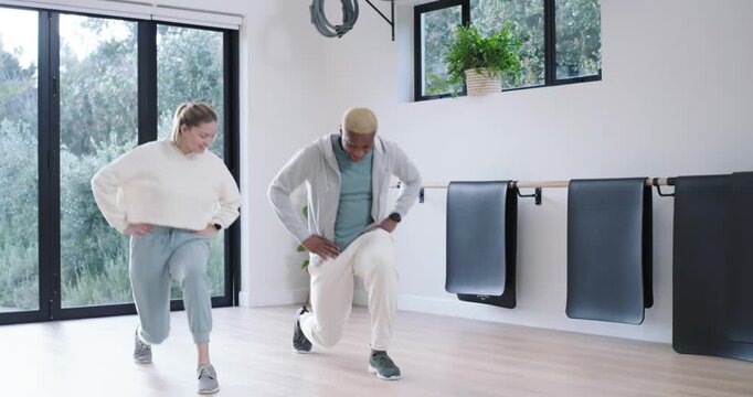 Diverse workout partners in studio with glass doors, man gesturing, leading, woman mirroring