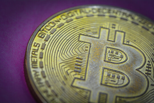 Physical bitcoin in colorful light for crypto currency and finance illustration purpose