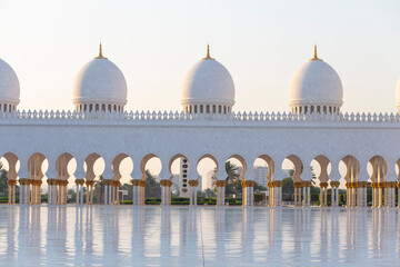 Domes and corridor on a great white marble mosque building landmark in Abu Dhabi © jordieasy