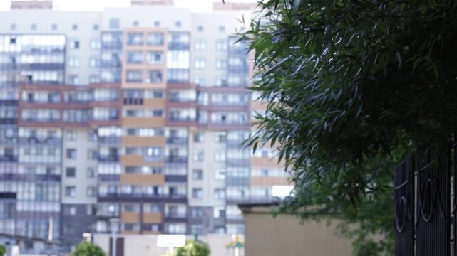 Blurred modern residential complex with multicolored facades forms urban backdrop