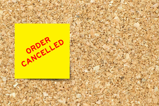 Yellow note paper with word order cancelled on cork board background with copy space