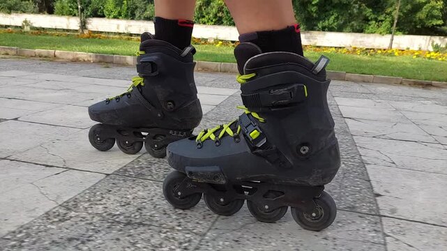 POV side view of roller skating on park broken tiles path with raw rolling wheels sound