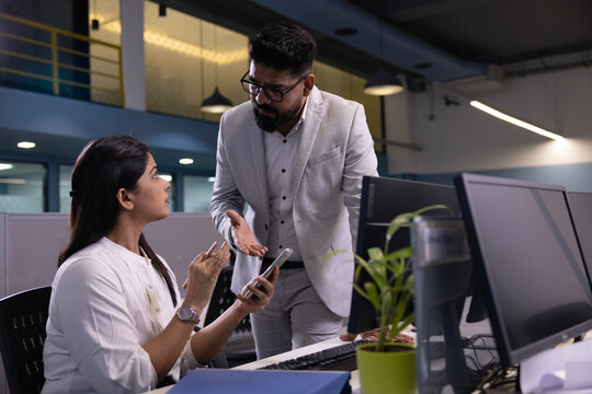 Asian angry businessman shouting at employee woman while standing in modern office. professional communication problem sitting at the desk who does not want to work seriously 