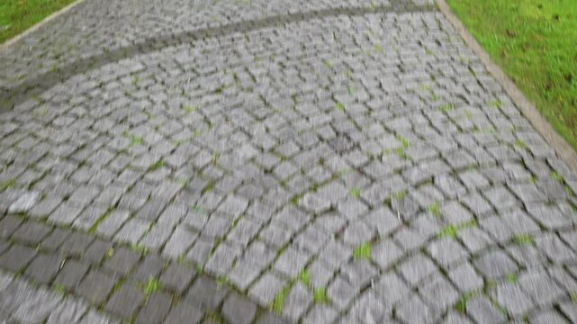 Footpath made of stones shows the design and texture of the ground in a park setting