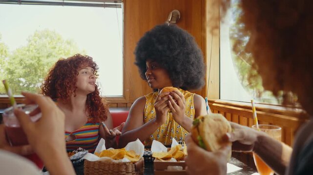 Cinematic footage about a group of multi-ethnic friends eating and having fun in an american styled diner restaurant.