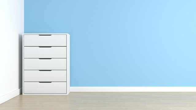 White chest of drawers against light blue wall with copy space