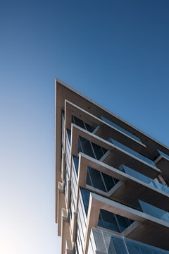bottom up architectural view on modern residential building against clear sky on sunny day, Abu Dhabi
