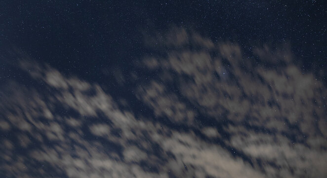 Thin clouds blowing in the night